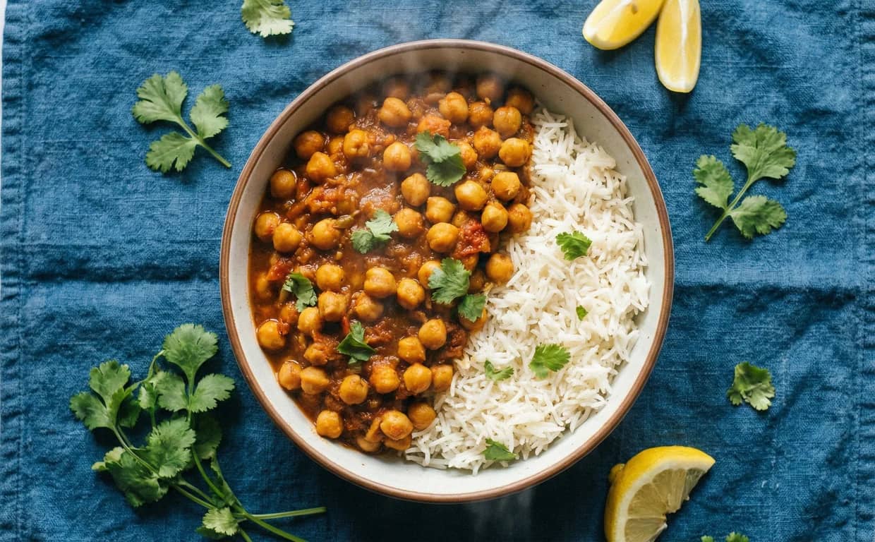Bowl of chana masala with rice and cilantro